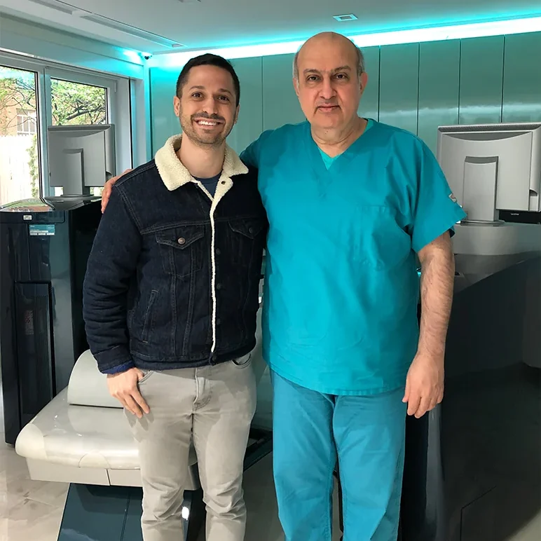 Dr. Khosorf standing with a happy patient
