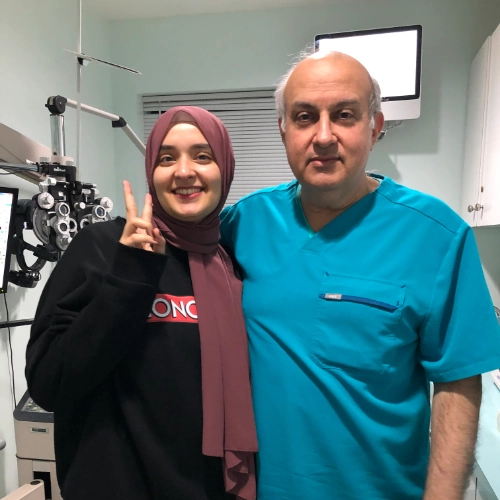 Happy patient next to Dr. Khosrof at vision consultation