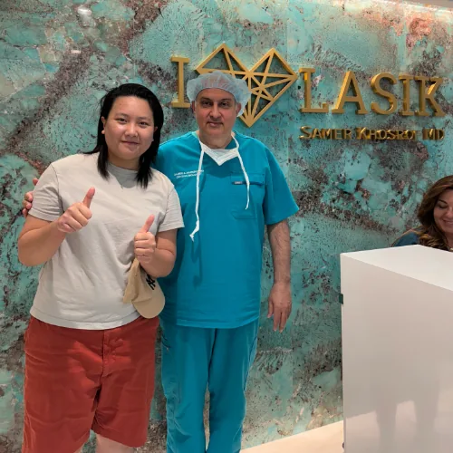 Dr. Khosorf standing with a happy patient