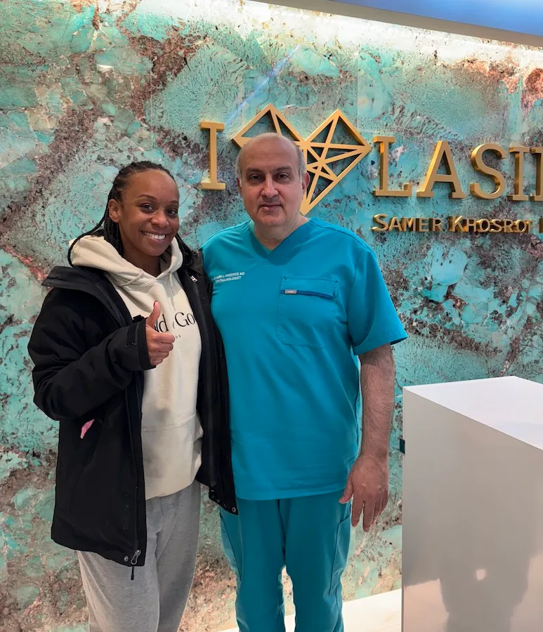 Dr. Khosorf standing with a happy patient