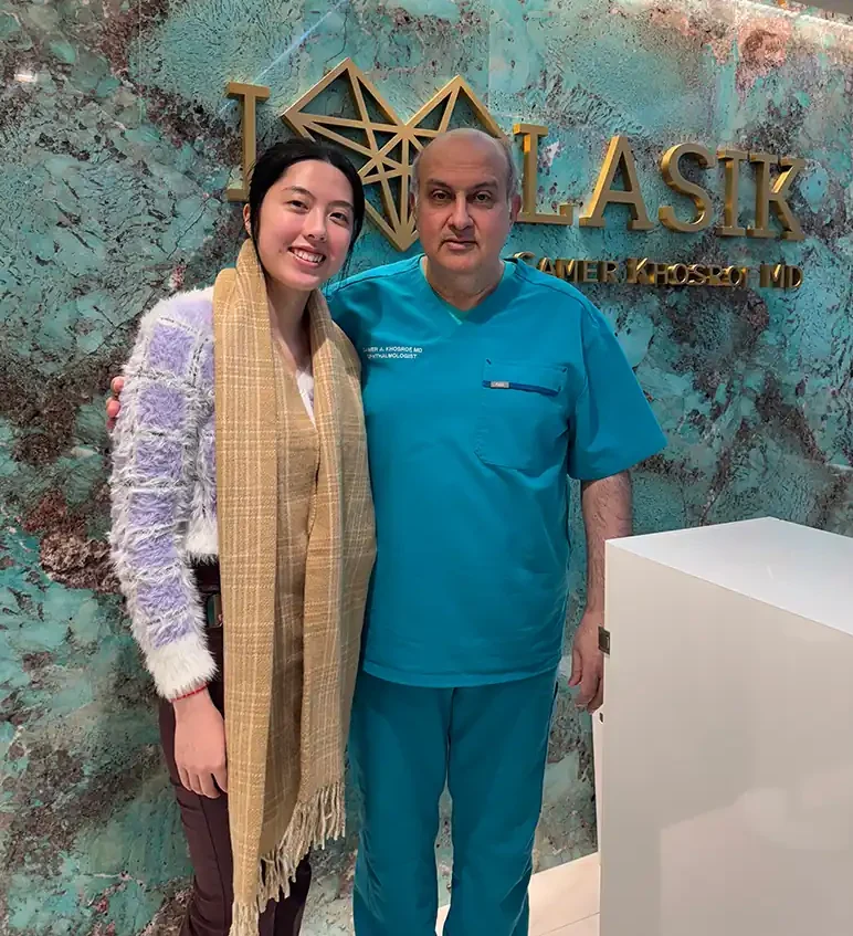 Dr. Khosorf standing with a happy patient