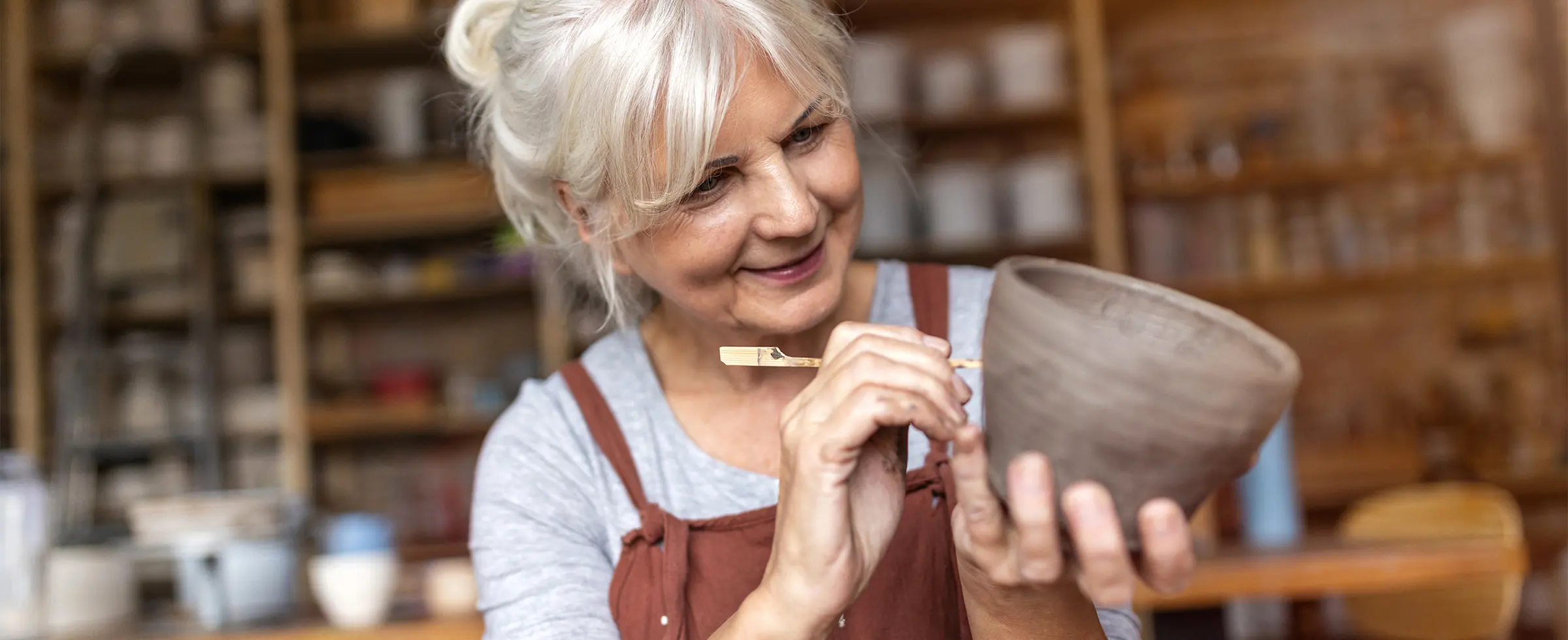 senior woman making pottery