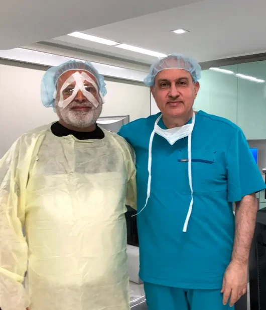dr khorsof with happy eldery patient post op in operating room