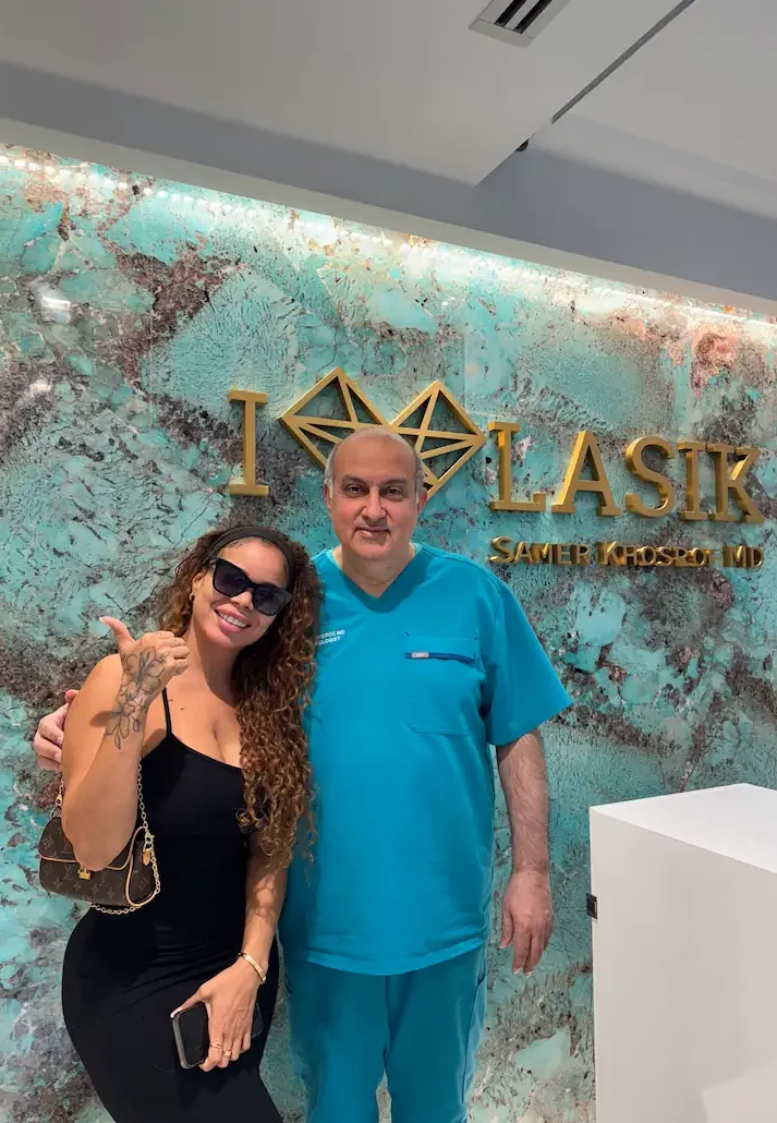 LASIK patient giving thumbs up next to Dr. Khosrof